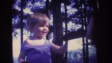 Baxter Maine USA (1975): Child Playing With Mother In The Trees And Giving Her A