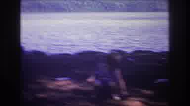 Baxter Maine USA (1975): A Little Boy Picking A Rock Up Off The Ground