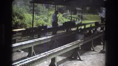 Baxter Maine USA (1975): A Man Stands In The Middle Of Train Tracks As A Train