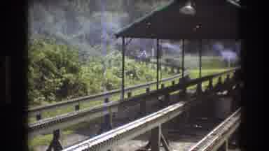 Baxter Maine USA (1975): A Smoking Train Coming Down The Tracks Towards The