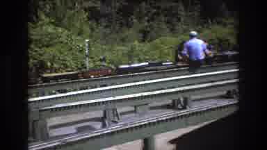 Baxter Maine USA (1975): People Sitting On Small Model Train Tracks While Tiny Toy