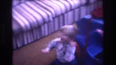 Baxter Maine USA (1975): Child Playing With Large Pedal Car In Living Room While A