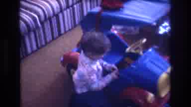 Baxter Maine USA (1975): Mother Watching Her Child Play With New Truck From Santa