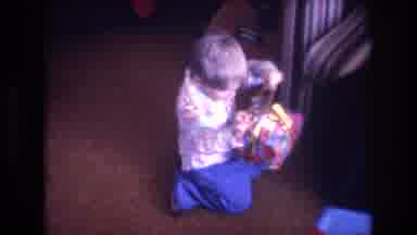 Baxter Maine USA (1975): Baby Opens Gift While His Mom Cheers Him On