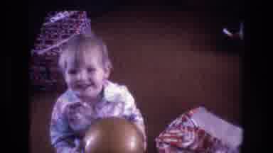 Baxter Maine USA (1975): Happy Toddler With New Ball In Hand At Christmas Time,