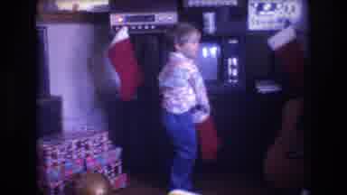 Baxter Maine USA (1975): Excited Child Opens Up His Red Stocking On Christmas