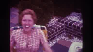 Boston USA (1975): Women With A Cigarette Waves On To Camera Person At A Party