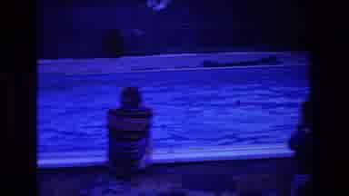 Boston USA (1975): Man In Striped Sweater Sitting Facing A Pool At Dusk