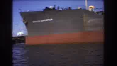 Boston USA (1975): Freighter Moors In Harbor To Deliver Oil Shipment With Small