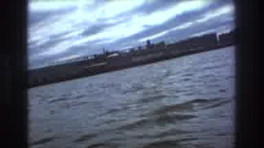 Boston USA (1975): Fast Moving Water Craft Quick Pan From Passengers To Shore With