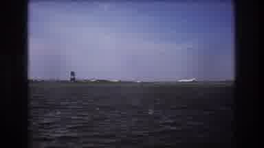 Boston USA (1975): Plane Taking Off From Runway Filmed From Water Point Of View