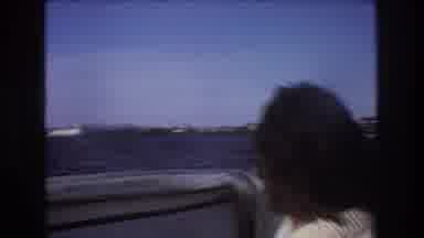 Boston USA (1975): A Man Rides At The Bow Of A Small Boat Moving Swiftly Through