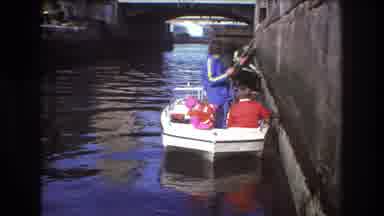 Boston USA (1975): A Tranquil Scene From The 1980s Of A Young Family Taking A Boat