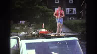 Boston USA (1975): A Boat Slowly Tightens A Tow Rope To Pull A Skier Off A Wooden
