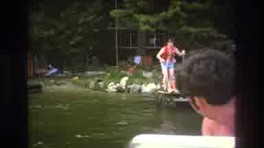 Boston USA (1975): Man Skiing Off Dock In Orange Vest