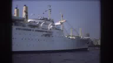 Boston USA (1975): Woman With Sunglasses Watching Cruise Ship Passing By On Water