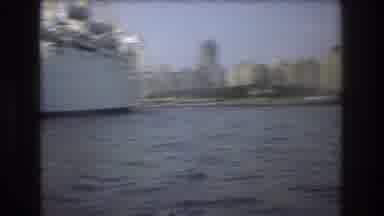 Boston USA (1975): Boating In A Ocean Near A Bigger Boat, Near Land