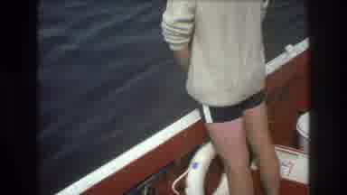 Boston USA (1975): First Person Standing By Boat Edge Second Persons Bends Over