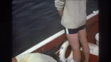 Boston USA (1975): Two Men On Board A Boat, One Is Standing, One Is Seated
