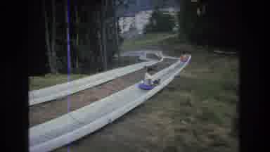 MT Bromley Vermont USA-1976: Young People Sliding Down Alpine Slide At Mountain Resort