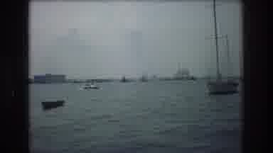 New York City USA (1976): People Riding In A Boat And Ships In The Water
