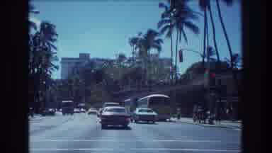 Honolulu Hawaii a USA (1977): A Car Driving In Older Days With A Bus On The Right