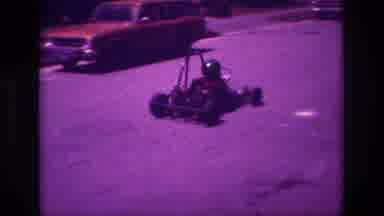 San Diego B USA (1981): Small Car With A Child Is Going Down The Road