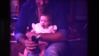 San Diego C USA-1981: Dad In Blue Shirt Holding Baby On Lap Showing Object
