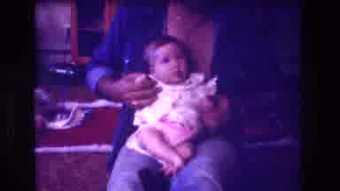 San Diego C USA (1981): Man Playing With Baby's Arms While Baby Is Sitting On His