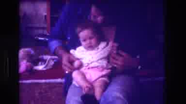 San Diego C USA (1981): Person With A Baby Sitting On Their Lap Playing
