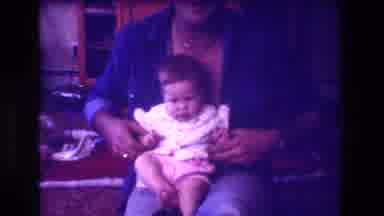San Diego C USA (1981): An Adult Sitting On A Chair While Holding A Baby Speaks To