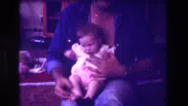 San Diego C USA (1981): Dad Holding Baby Girl, Camera Pans To View The Living