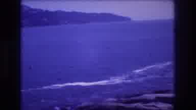 Acapulco Mexico (1982): Pan Left Inside Cove With Foothills, Boat, And Hotels On