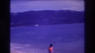 Acapulco Mexico (1982): Child Walking Along Beach While Waves Are Rolling In