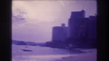 Acapulco Mexico (1982): Man Glides Across Beach And Into The Ocean With City View