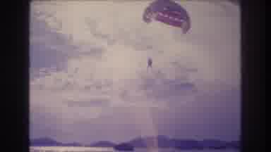 Acapulco Mexico (1982): Person With A Red Parachute Paragliding In A Cloudy Blue