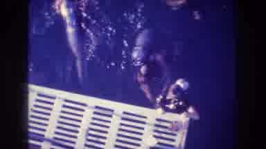 Acapulco Mexico (1982): Two Scuba Divers Hanging On To A Platform As Another Scuba