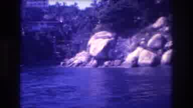 Acapulco Mexico (1982): Trees And Rocks Along The Lake Shoreline With A City