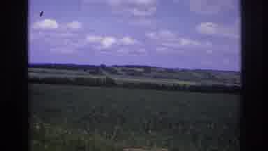 France-1967: A Green Field With Rolling Hills Under a Blue Sky