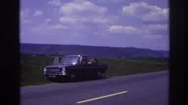 France (1967): Man Sitting Inside His Car At The Side Road Waving And Seems To Be