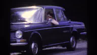France (1967): Man Sitting In A Car By The Side Of The Road, Appearing To Be