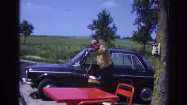 France (1967): A Man In A Yellow Shirt Getting Into A Black Car