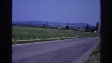 France (1967): A Bustling Green Field Borders A Sleepy Looking Farm Town