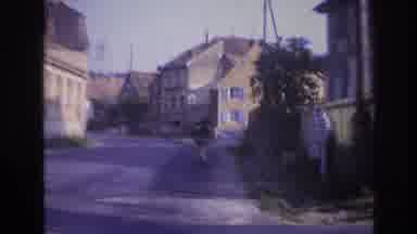 France (1967): Riding A Bike Down The Street In A Old Town