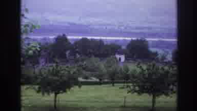 France (1967): View With Trees Grass And Distant City With Woman In A Car At The