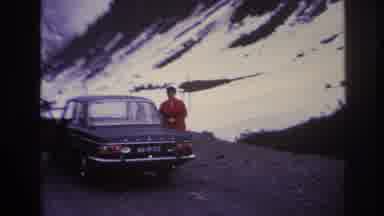 France (1967): Women In Red Coat And Hat Enters Car On Road In The Mountains