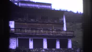France (1967): Person Driving Filming Town Buildings And Houses With Mountain Top