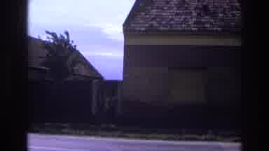 France (1967): A Man In His Car Pulling Up To His House On A Windy Day