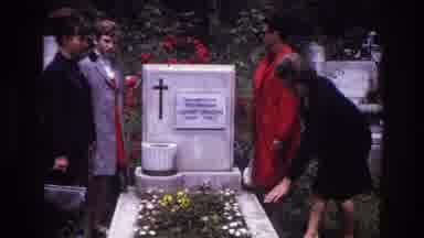 France (1967): A Group Of Four People Mourns The Flower Ridden Grave Of A Lost