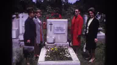 France (1967): A Group Of Four People Mourns The Flower Ridden Grave Of A Lost